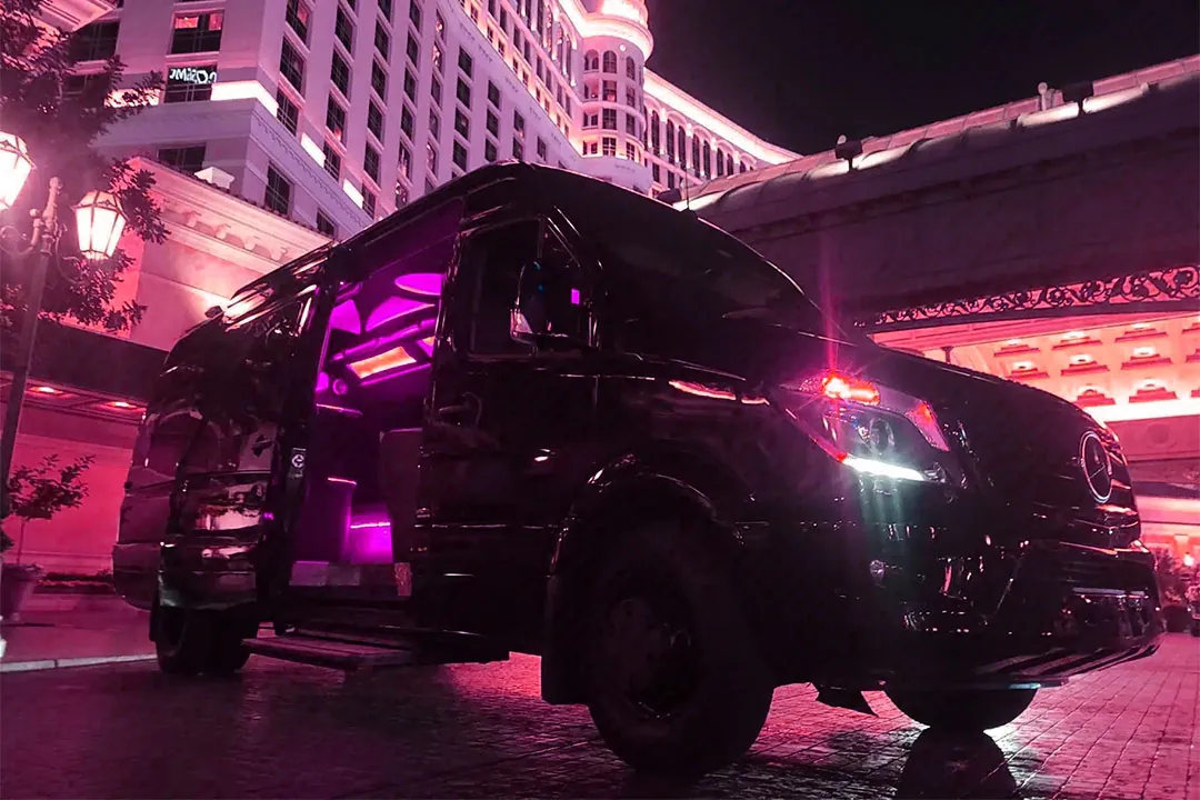 Black Sprinter van with pink lights, LVSC's free ride from your hotel